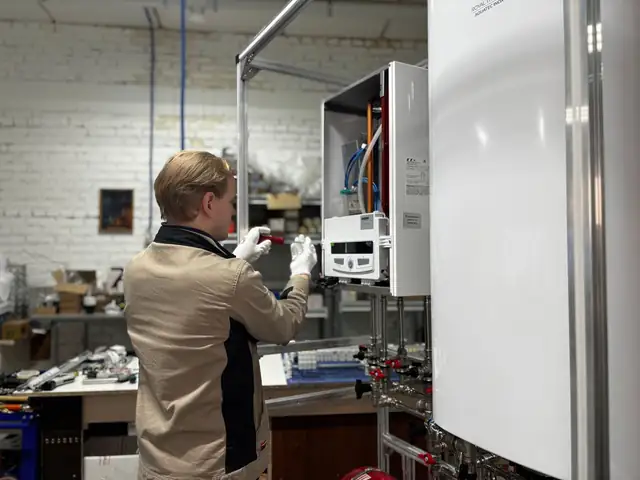 Technician repairing a furnace in a workshop